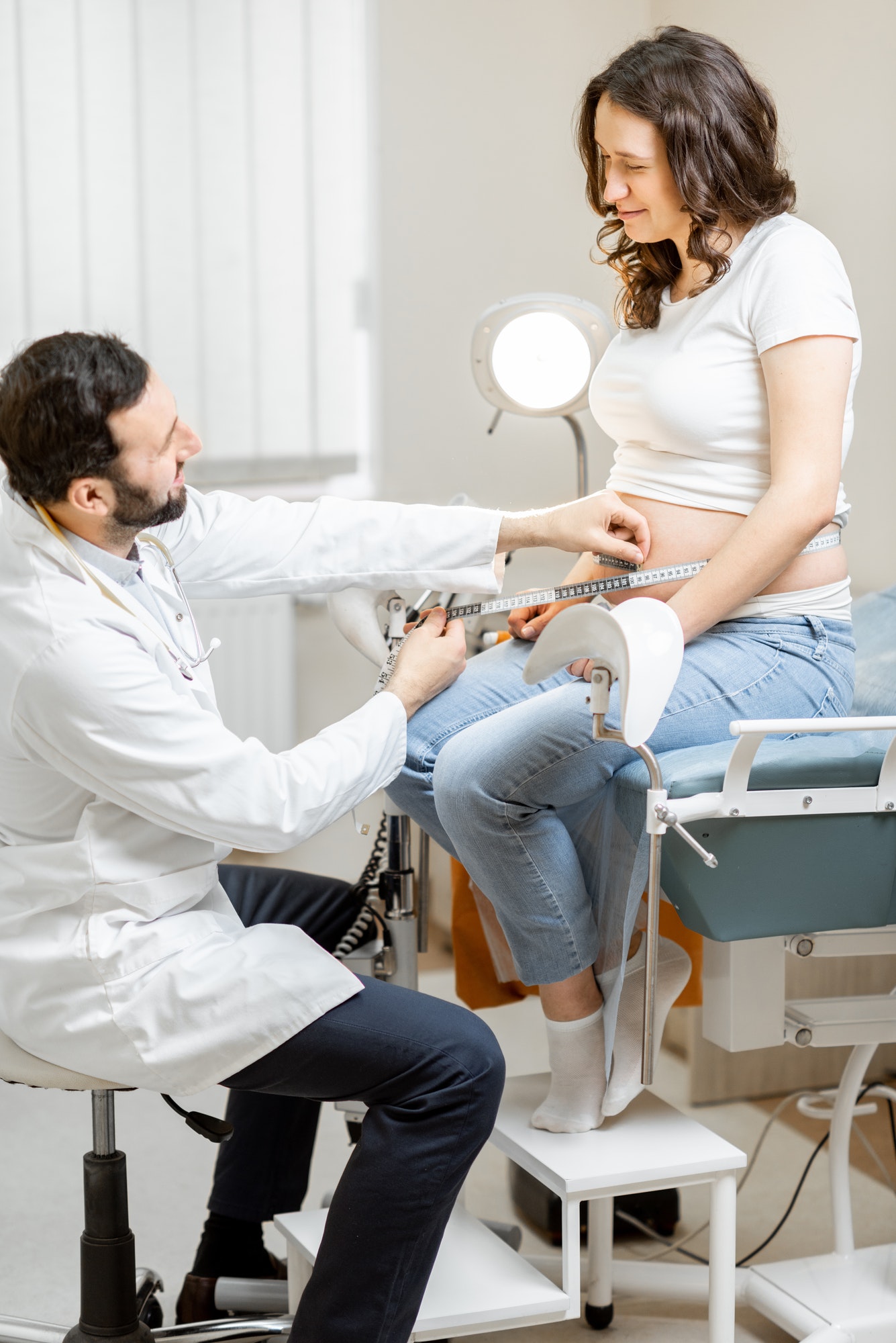 Doctor measuring pregnant woman's belly